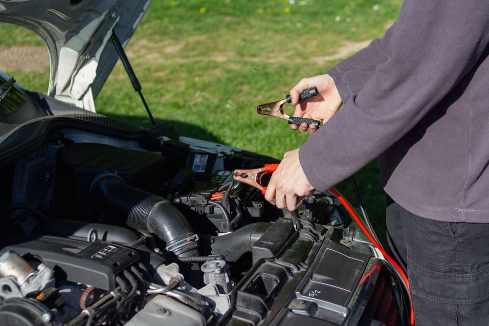 Charger clamps attached to a car battery