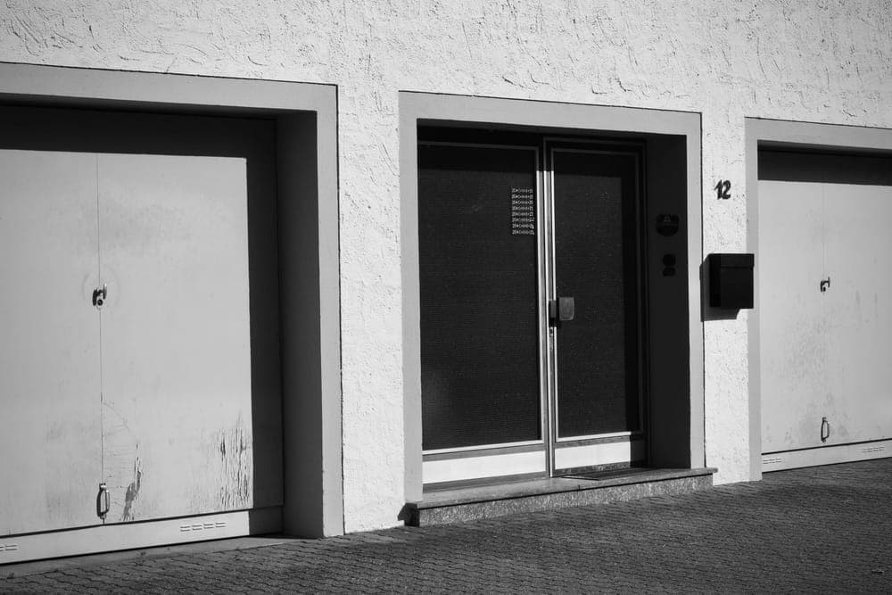 The bottom edge of a closed garage door meeting a concrete floor
