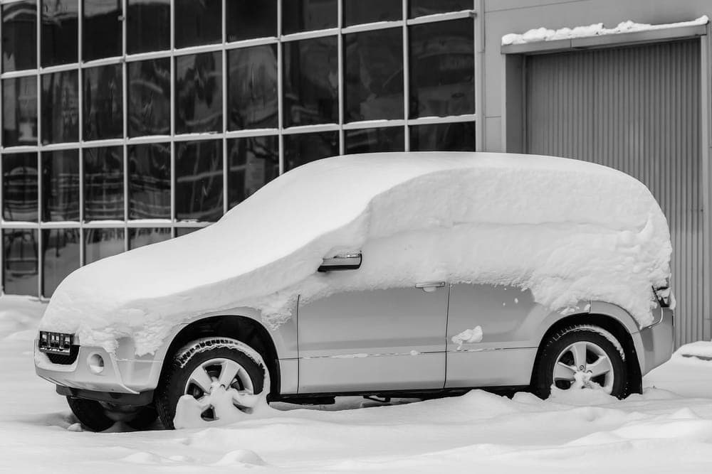 A car windshield covered against overnight snow