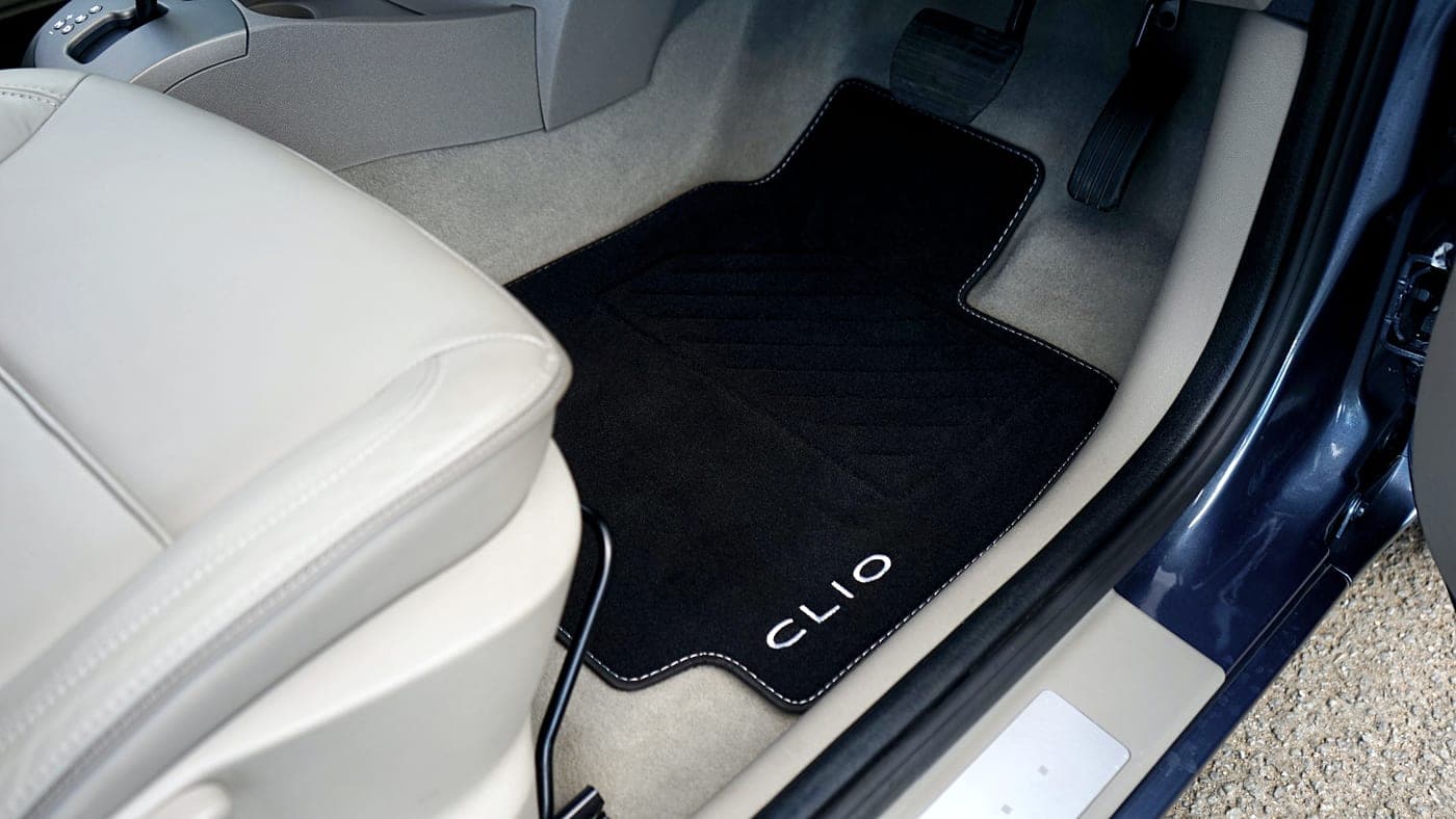 A car footwell with a mat covering the carpet