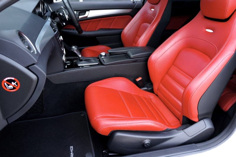 A car footwell with a rubber all-weather mat in place - a stand-in for the WeatherTech All-Weather Floor Mats, not a photograph of this model
