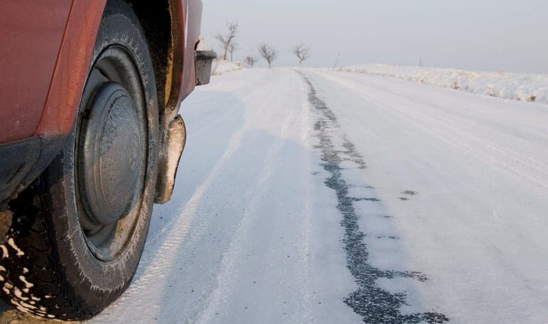 A tire in deep snow, where a textile snow sock is used - a stand-in for the AutoSock Textile Snow Sock, not a photograph of this model